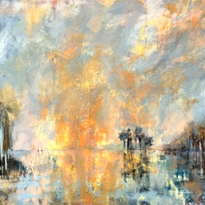 Sunset over a water scene with palm trees along a calm shore, reflected clouds and warm golden light spilling across the sky.