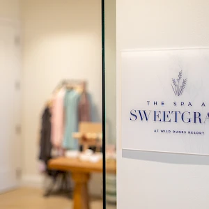 A spa sign on a glass door says “The Spa at Sweetgrass.”