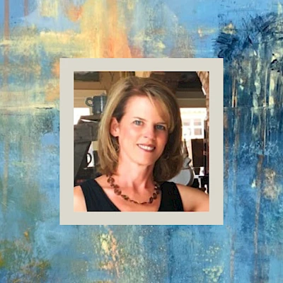 A colorful abstract blue-and-warm-toned painting with a small framed photo of a woman at the center, wearing a black top and necklace, smiling.