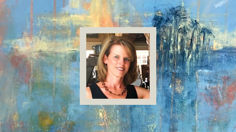 A colorful abstract blue-and-warm-toned painting with a small framed photo of a woman at the center, wearing a black top and necklace, smiling.
