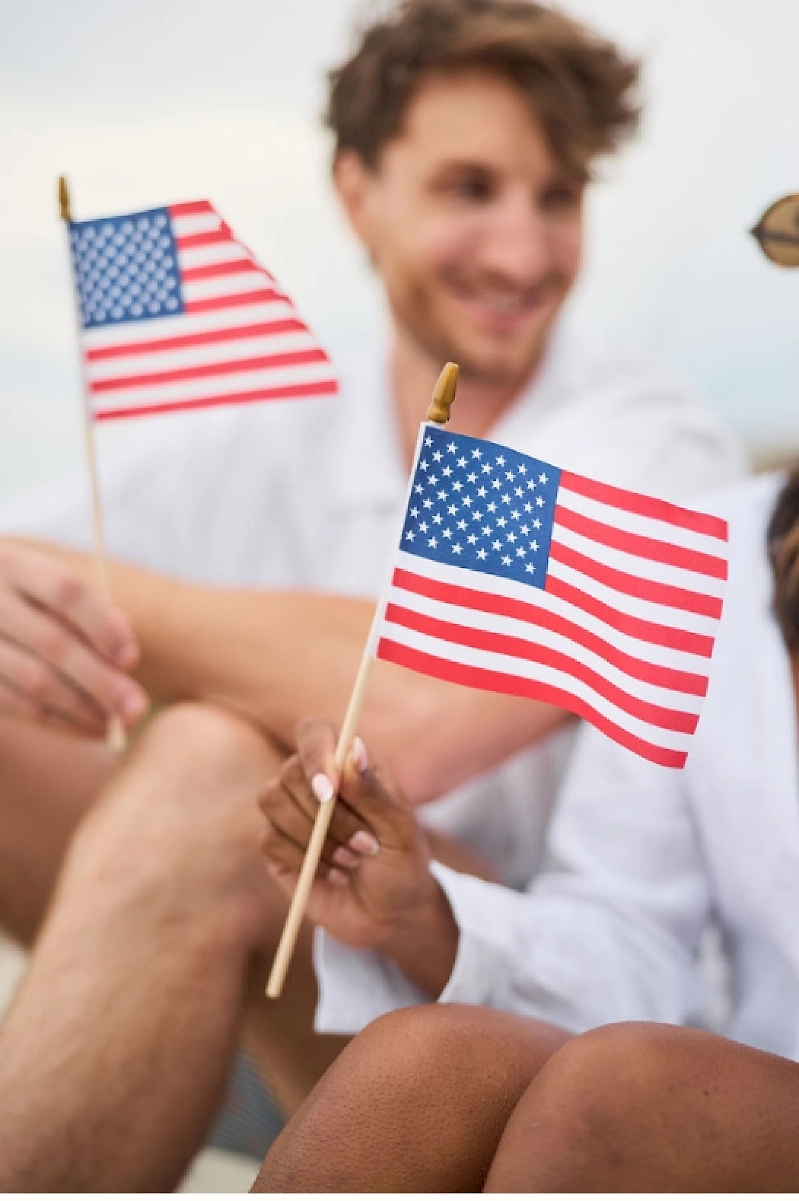 Couple Holding American Flags