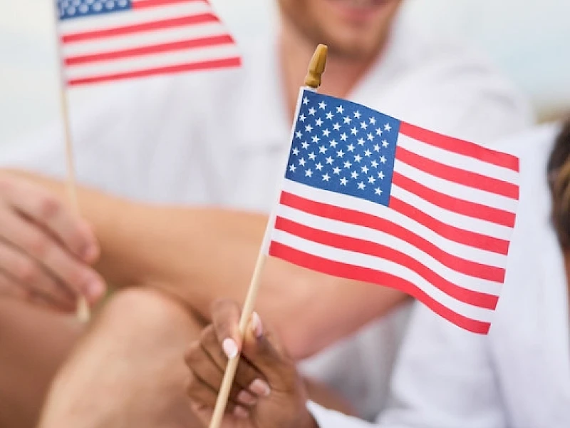 Couple Holding American Flags
